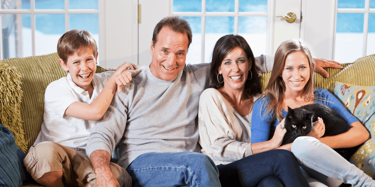 Family on couch enjoying central air