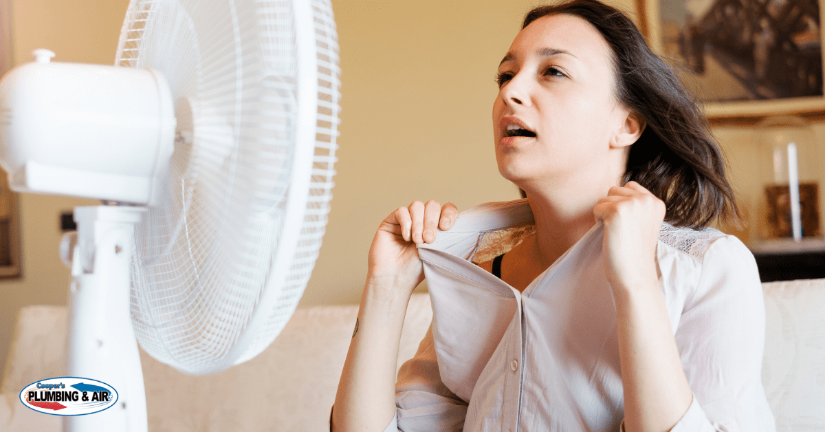 ac short cycling, woman cooling off in front of a fan